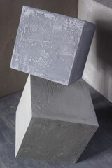 Concrete cube near wall background texture. Art or construction concept of minimalism design