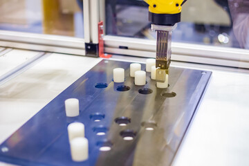 Pick and place robotic clamp arm manipulator moves and lifts objects at modern robot exhibition, trade show - close up view. Manufacturing, industrial, engineering and automated technology concept