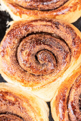 Fototapeta premium Top view of homemade cinnamon rolls. Close-up of a sweet bun.