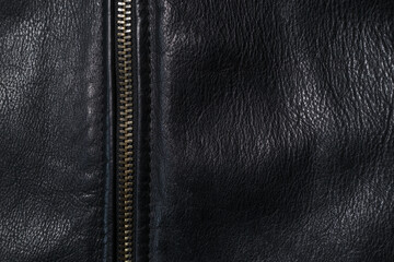 Black leather background with metal zipper