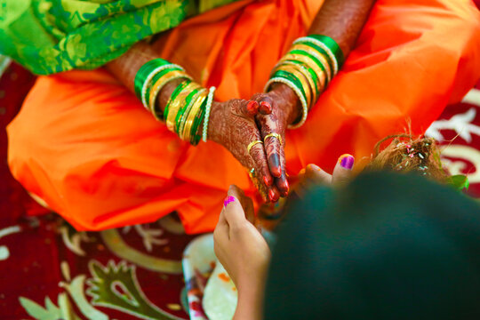 Hands of bride is decorated beautifully by indian mehndi art along with jewelery&rsquo;s and colorful bangles