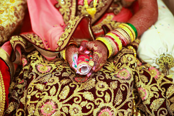 Hands of bride is decorated beautifully by indian mehndi art along with jewelery’s and colorful bangles