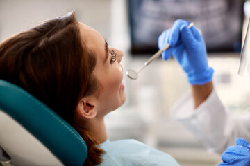 Close-up of woman having her teeth checked at dentist's office.