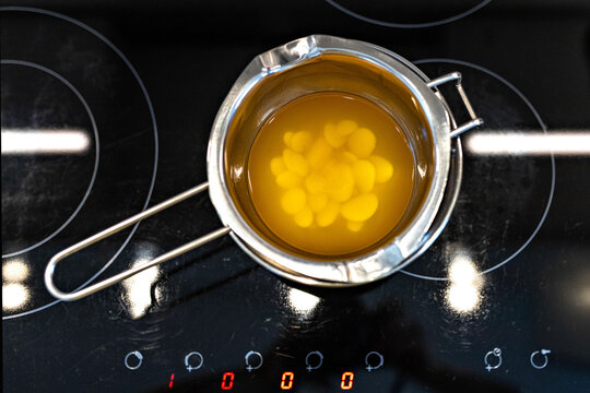 Top View Of Organic Cocoa Butter Melted In A Water Bath For The Preparation Of Body Skin Care Cosmetics. Cooking Process. Home Spa. Small Business