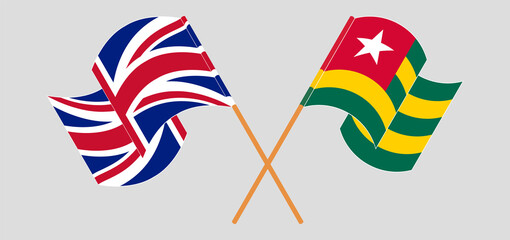 Crossed and waving flags of the UK and Togo