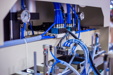 Part of automatic injection molding machine and flexible plastic hoses at exhibition, trade show....