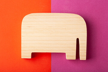 Elephant figurine carved from solid pine by hand jigsaw. On a multi-colored background