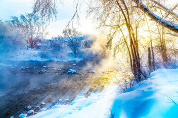 Winter landscape. The sun shines in the photo camera. the trees and grass frost. water in river heavy fog