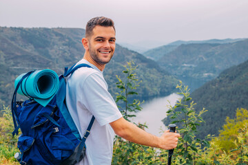 young man outdoors hiking with natural landscape
