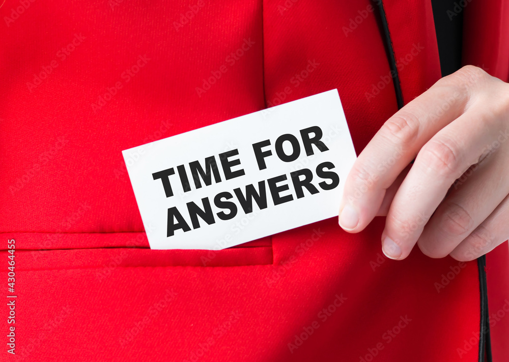 Poster time for answers. woman holding a card with a message text written on it and puts it in jacket pocke