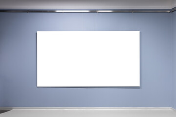 Blank white poster with copy space area hangs on blue wall