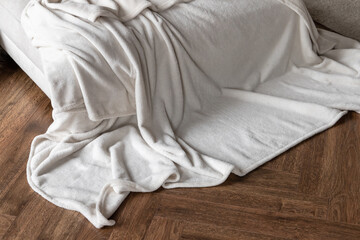 Bedroom interior fragment with soft white blanket
