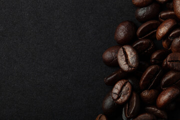 Roasted coffee beans on the black background for wallpaper or decor
