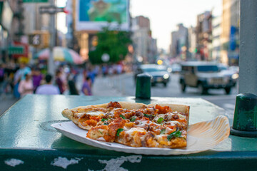 a lone slice of pizza on Canal street in New York City