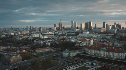 Aerial view of the old town and city. The shot is taken during dawn. City of Warsaw, Poland waking up. Skyscrapers and residential apartments against a scenic blue cloudy sky in the background.