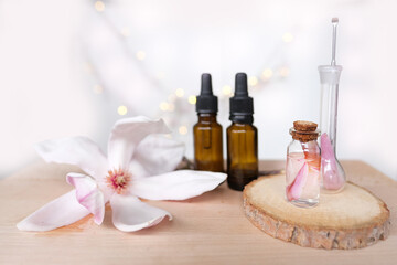 Fototapeta na wymiar oil, tincture, creating a new medicine from plants, gifts of nature, dietary supplements, magnolia flowers, concept science, natural medicine, pharmacology