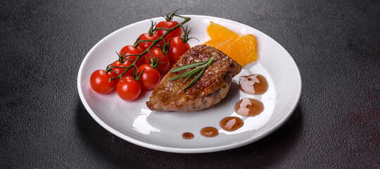 Baked duck breast with herbs and spices on a dark concrete background