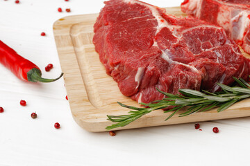 Beef tenderloin on wooden board on wooden table