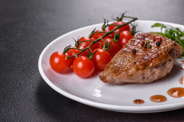 Baked duck breast with herbs and spices on a dark concrete background