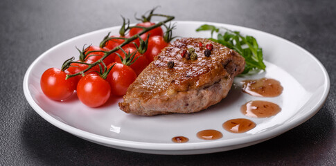 Baked duck breast with herbs and spices on a dark concrete background