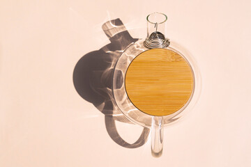 glass teapot with a hard shadow on a colored background