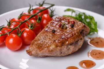 Baked duck breast with herbs and spices on a dark concrete background