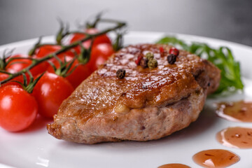 Baked duck breast with herbs and spices on a dark concrete background