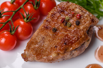 Baked duck breast with herbs and spices on a dark concrete background
