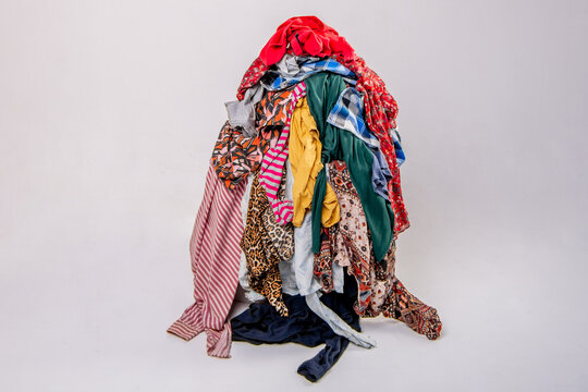 Pile of used clothes on a light background. Second hand for recycling
