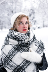 Winter portrait of a woman in a white hat and gloves