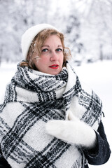 Winter portrait of a woman in a white hat and gloves
