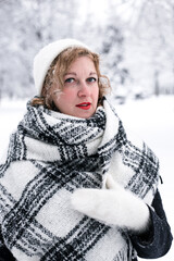 Winter portrait of a woman in a white hat and gloves