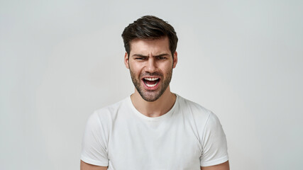 Young bearded man wearing t-shirt shouting