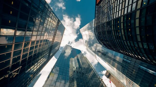 Bottom-up rotating timelapse of important and futuristic skyscrapers in the financial center of a major city