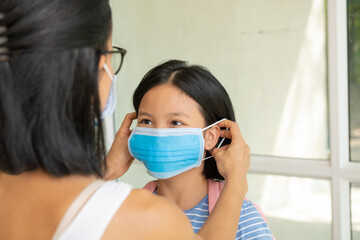 Family with kids in face mask. Mother and child wear facemask during coronavirus and flu outbreak. Virus and illness protection, hand sanitizer in public crowded place.