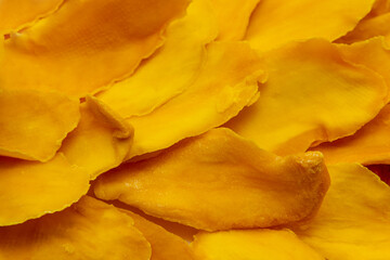 Naklejka premium Closeup of many slices of dried mango without sugar. Background image.