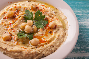 vegan food. close-up hummus with parsley and smoked paprika