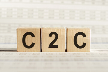 C2C abbreviation - consumer to consumer, on wooden cubes on a light background.