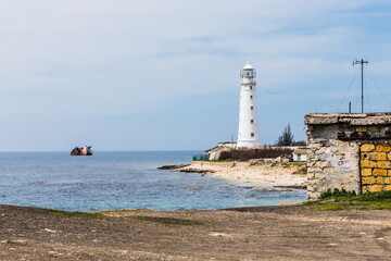 Fototapeta premium Rocky coast of the Tarkhankut peninsula - the westernmost part of Crimea. The white lighthouse