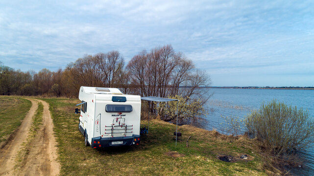Fiat Ducato. Motorhome. Roller Team Zefiro Garage (Alcove). cloudy winter day. RV in Spring lake and field background. Moscow Oblast, Russia 04.19.2021