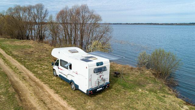 Fiat Ducato. Motorhome. Roller Team Zefiro Garage (Alcove). cloudy winter day. RV in Spring lake and field background. Moscow Oblast, Russia 04.19.2021