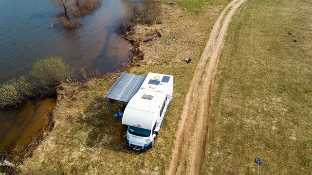 Fiat Ducato. Motorhome. Roller Team Zefiro Garage (Alcove). cloudy winter day. RV in Spring lake and field background. Moscow Oblast, Russia 04.19.2021