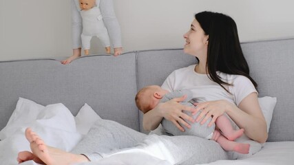 Breast feeding mama at home. Baby breastfeed on mothers hands, Cuddle a baby and talking to son