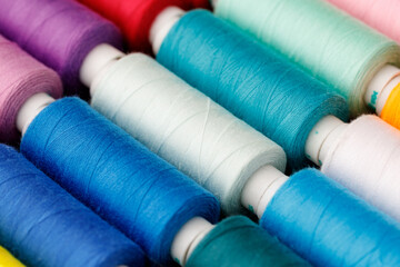 Close up of colored thread coils, thread spools background