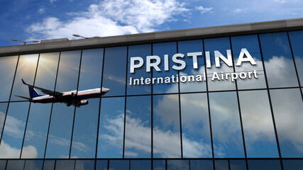 Airplane landing at Pristina Kosovo airport mirrored in terminal