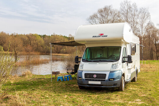 Fiat Ducato. Motorhome. Roller Team Zefiro Garage (Alcove). cloudy winter day. RV in Spring lake and field background. Moscow Oblast, Russia 04.19.2021