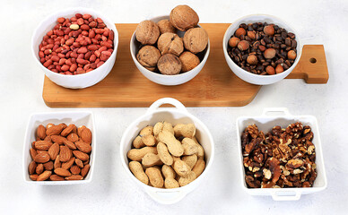 Assortment of different nuts, healthy natural food concept, almonds, pecans, pistachios, cashews, walnuts and pine nuts, high-calorie food with vegetable protein and vitamins, dietary nutrition basis,