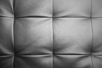 Detailed background of soft furniture leather or leatherette surface. Black white textured background.
