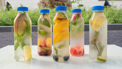 Variety of detox water on a plastic container, health concept
