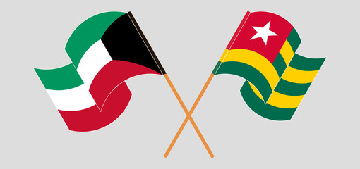 Crossed and waving flags of Kuwait and Togo